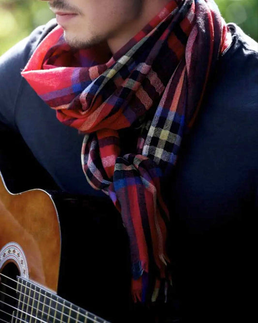 Lightweight royal stuart scarf in 100% cashmere on male model playing guitar