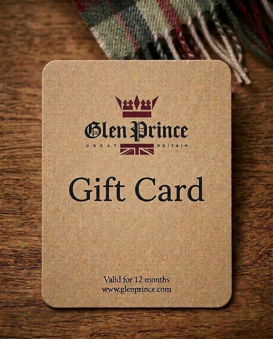 Glen Prince gift card with logo indicating valid 12 months with a crown logo, resting on a wooden surface next to a tartan scarf.