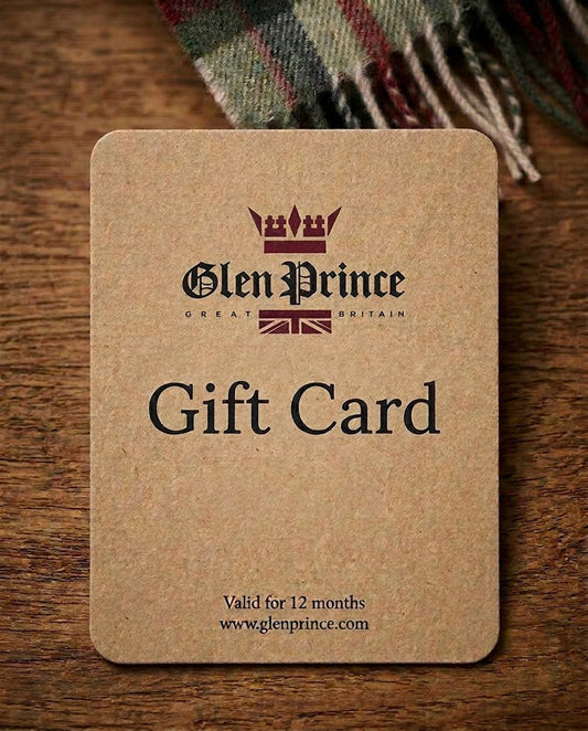 Glen Prince gift card with logo indicating valid 12 months with a crown logo, resting on a wooden surface next to a tartan scarf.